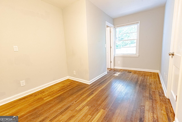 unfurnished room featuring hardwood / wood-style floors