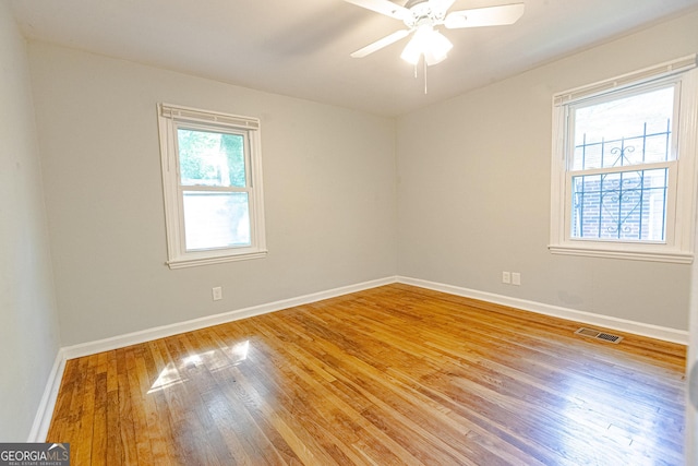 spare room with wood-type flooring and ceiling fan