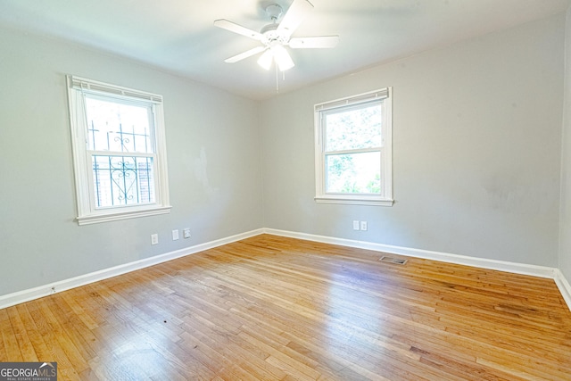 unfurnished room with plenty of natural light, ceiling fan, and light hardwood / wood-style flooring