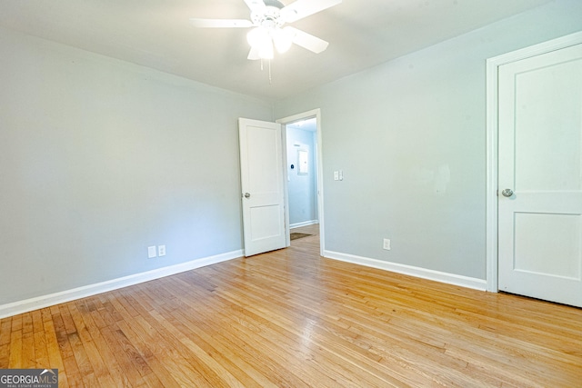 empty room with light hardwood / wood-style floors and ceiling fan