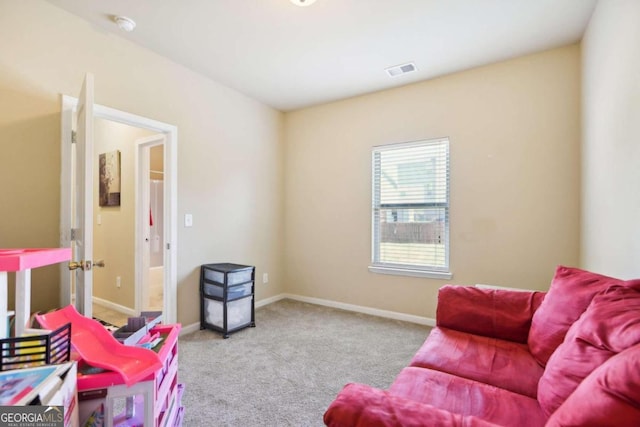 living area featuring carpet floors and baseboards