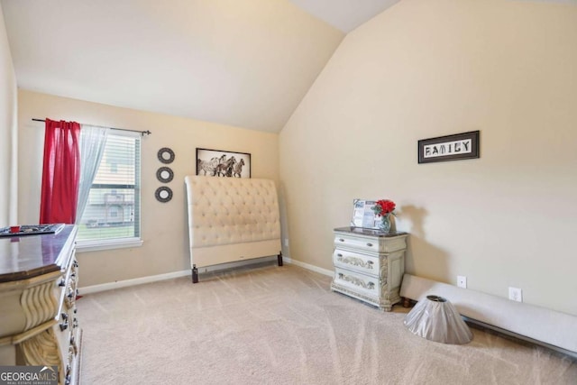 carpeted bedroom with vaulted ceiling and baseboards