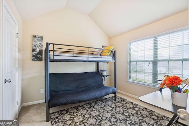bedroom featuring lofted ceiling, baseboards, and carpet floors