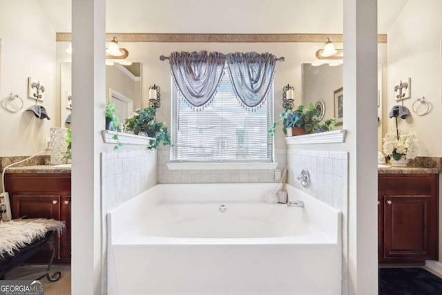 bathroom featuring a garden tub and vanity
