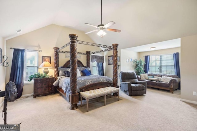 bedroom with light colored carpet, vaulted ceiling, baseboards, and ceiling fan