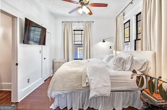 bedroom featuring dark hardwood / wood-style floors and ceiling fan