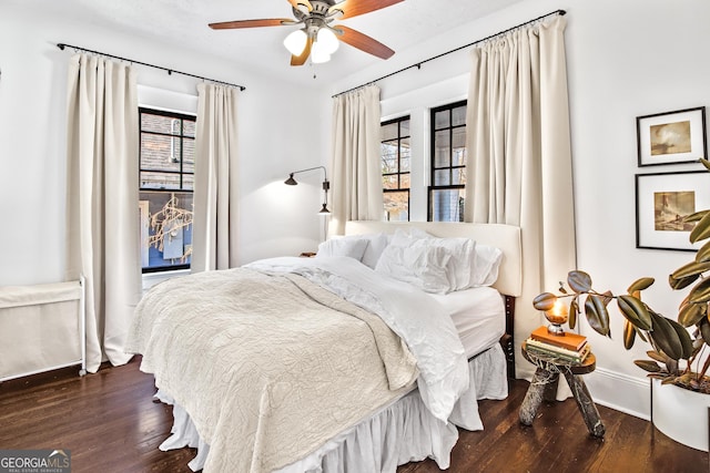 bedroom with ceiling fan and dark hardwood / wood-style floors