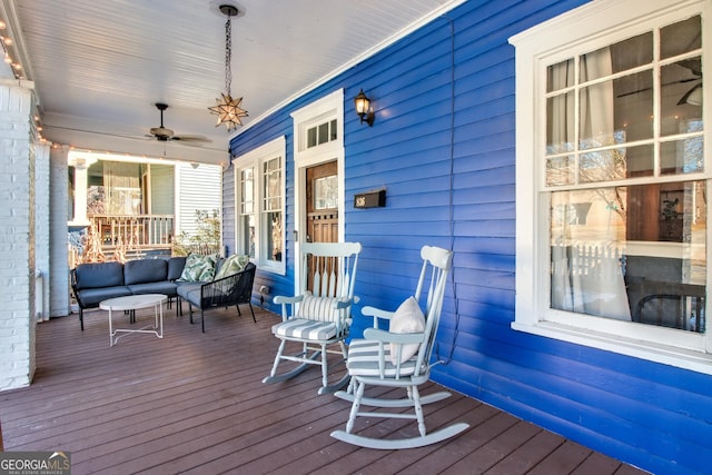 wooden deck featuring a porch and ceiling fan