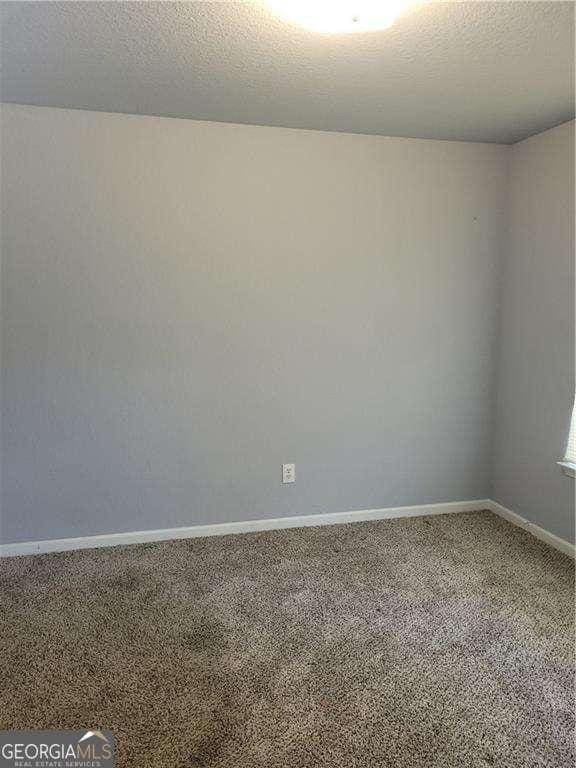 unfurnished room with carpet flooring