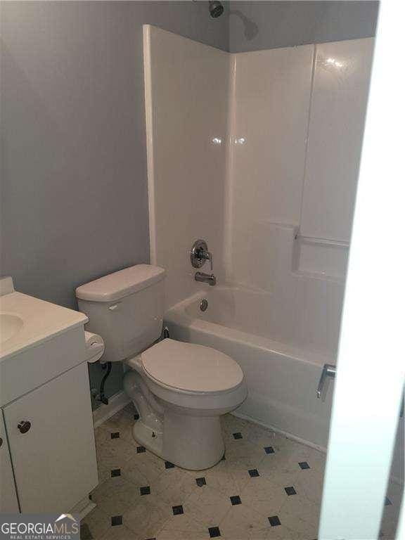 full bathroom with vanity,  shower combination, and toilet