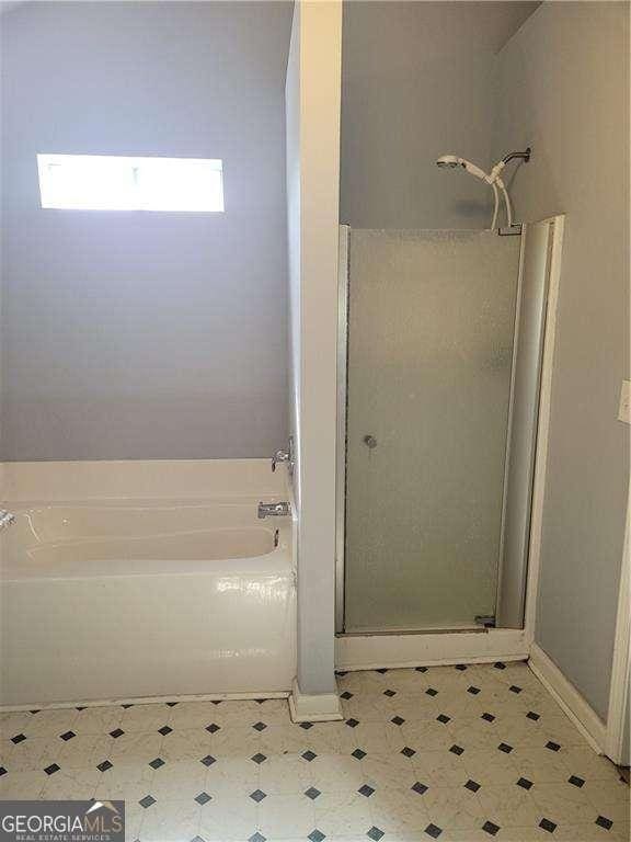 bathroom featuring plus walk in shower