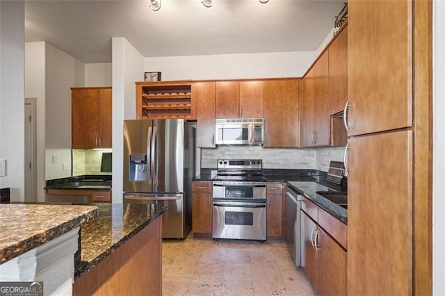 kitchen featuring backsplash, dark stone countertops, and stainless steel appliances