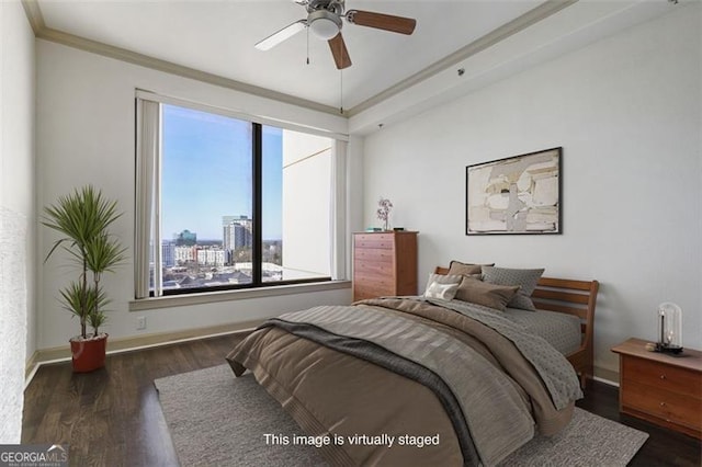 bedroom with ceiling fan, dark hardwood / wood-style floors, and ornamental molding