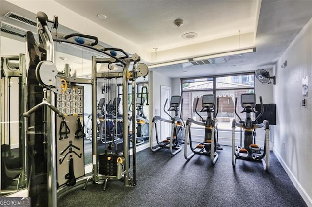 workout area with a raised ceiling