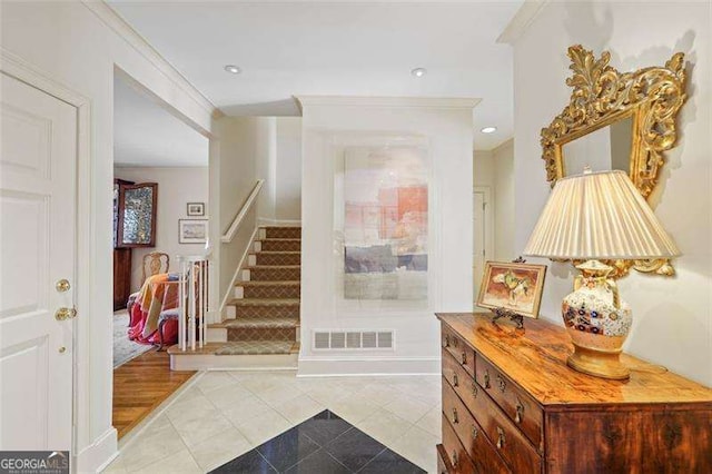 tiled entryway with ornamental molding