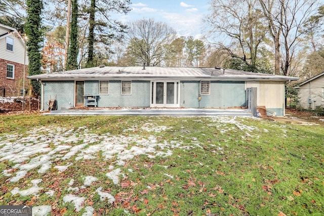 back of property with a patio and a lawn