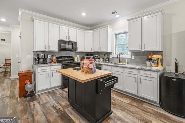 kitchen featuring wood counters, black appliances, decorative backsplash, a kitchen island, and white cabinetry