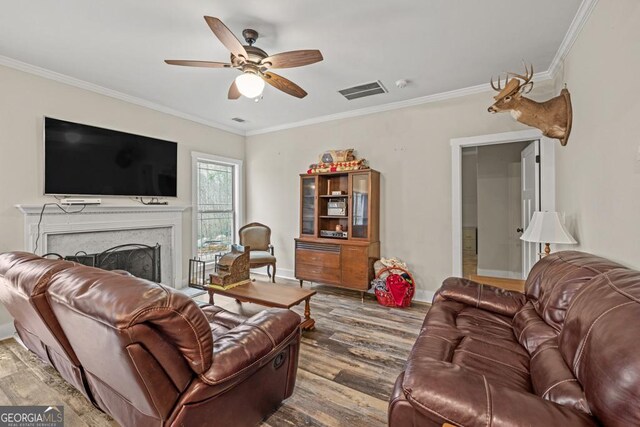 192 Celestial Run, Winder, GA 30680 - living room featuring wood finished floors, ornamental molding, a ceiling fan, baseboards, and a fireplace