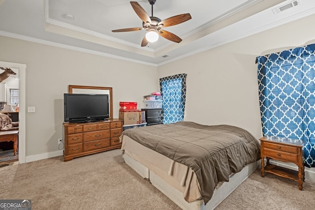 bedroom featuring a tray ceiling, ceiling fan, crown molding, and light carpet