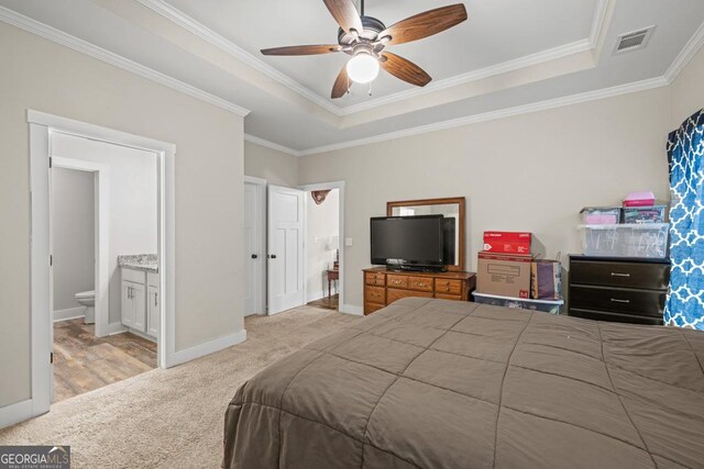 192 Celestial Run, Winder, GA 30680 - carpeted bedroom featuring a tray ceiling, crown molding, baseboards, ensuite bath, and ceiling fan