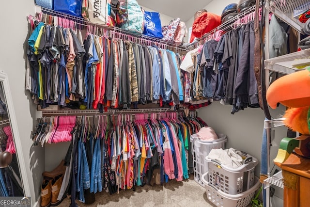 walk in closet with carpet