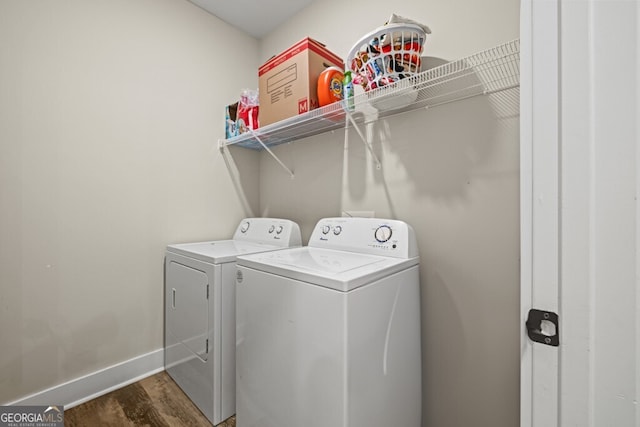 laundry room featuring dark hardwood / wood-style flooring and washing machine and clothes dryer