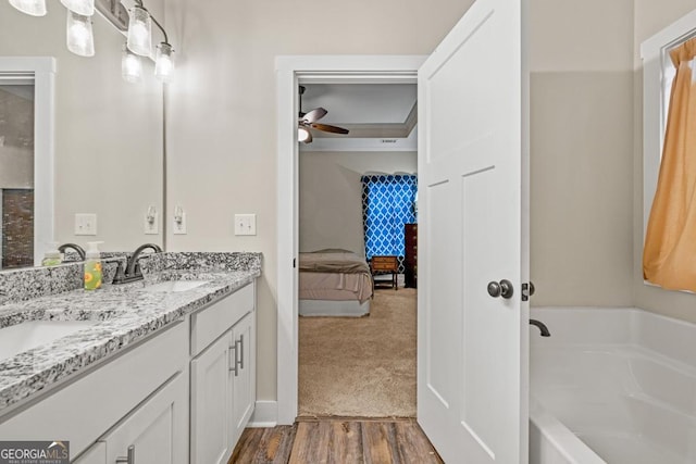 192 Celestial Run, Winder, GA 30680 - bathroom with a bath, a ceiling fan, double vanity, ensuite bath, and wood finished floors