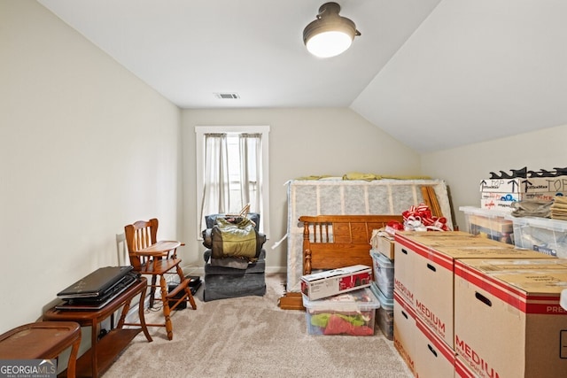 bedroom with light colored carpet and lofted ceiling