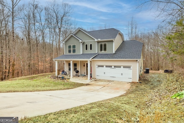 view of front of property with a garage, covered porch, a front yard, and central AC