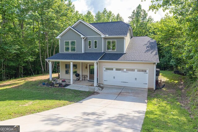 192 Celestial Run, Winder, GA 30680 - view of front of house featuring covered porch, driveway, an attached garage, roof with shingles, and a front lawn