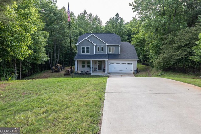 192 Celestial Run, Winder, GA 30680 - traditional-style house featuring covered porch, concrete driveway, a front yard, and a forest view