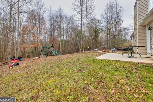 view of yard featuring a playground and a patio