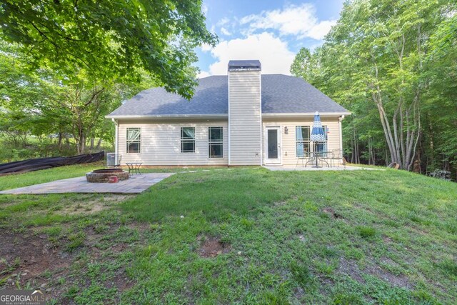 192 Celestial Run, Winder, GA 30680 - back of house with a fire pit, a patio, a chimney, and a lawn