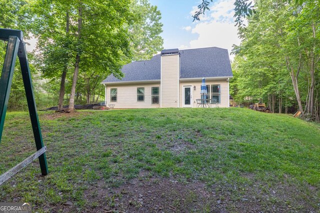 192 Celestial Run, Winder, GA 30680 - back of property with a chimney, a lawn, and a shingled roof