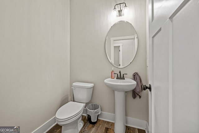 bathroom featuring sink, wood-type flooring, and toilet