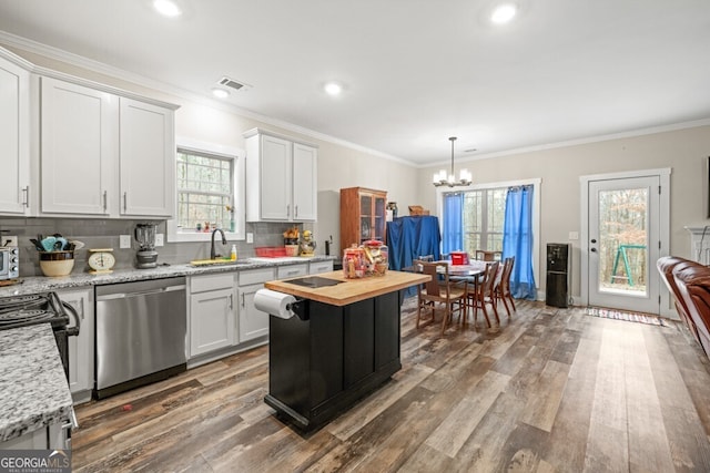 kitchen with stainless steel dishwasher, a notable chandelier, dark hardwood / wood-style floors, white cabinetry, and butcher block counters