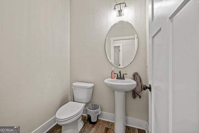 192 Celestial Run, Winder, GA 30680 - half bath with toilet, baseboards, wood finished floors, and a sink