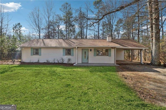 ranch-style house with a front yard and a carport