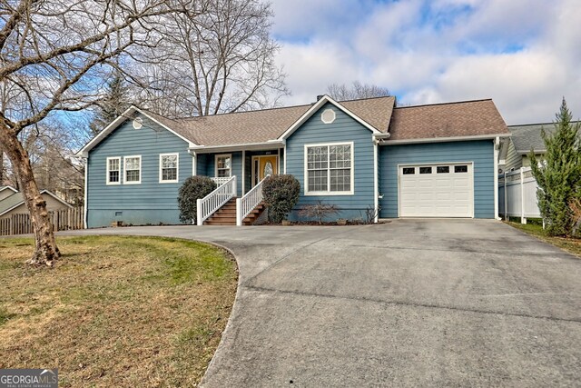 ranch-style home with a front yard and a garage