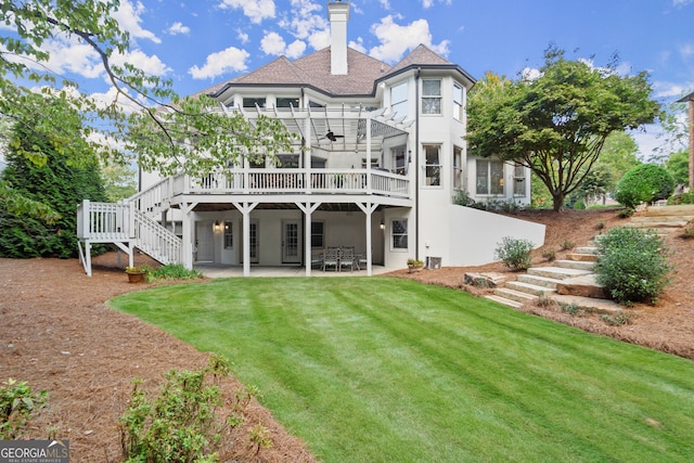 rear view of property with a yard, a patio area, and a wooden deck