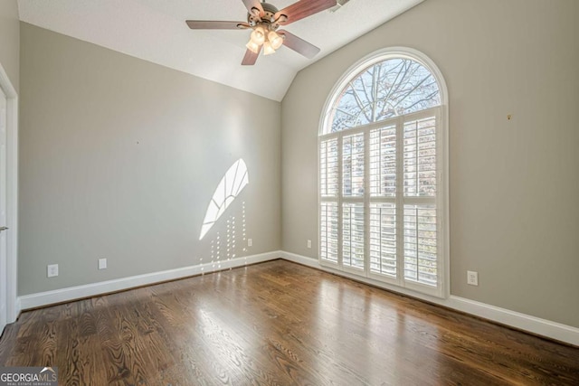 empty room with dark hardwood / wood-style floors, ceiling fan, and lofted ceiling