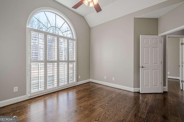 empty room featuring ceiling fan, dark hardwood / wood-style flooring, and lofted ceiling