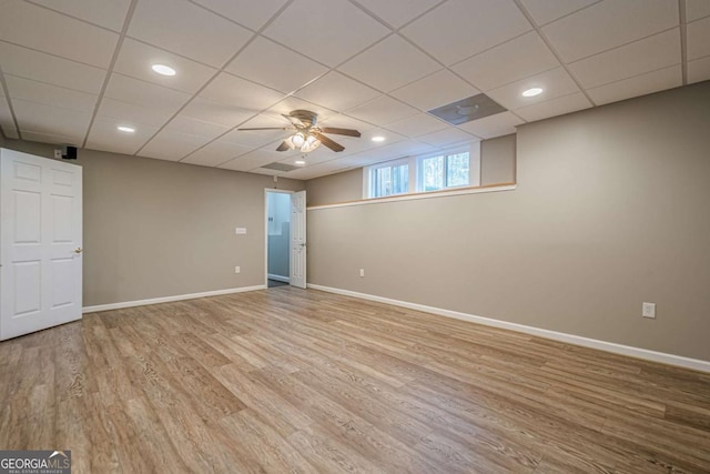 interior space featuring a paneled ceiling, ceiling fan, and light hardwood / wood-style flooring