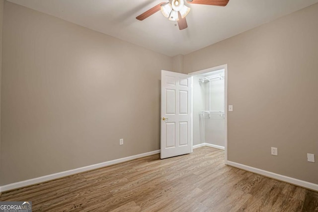 unfurnished room with ceiling fan and light wood-type flooring