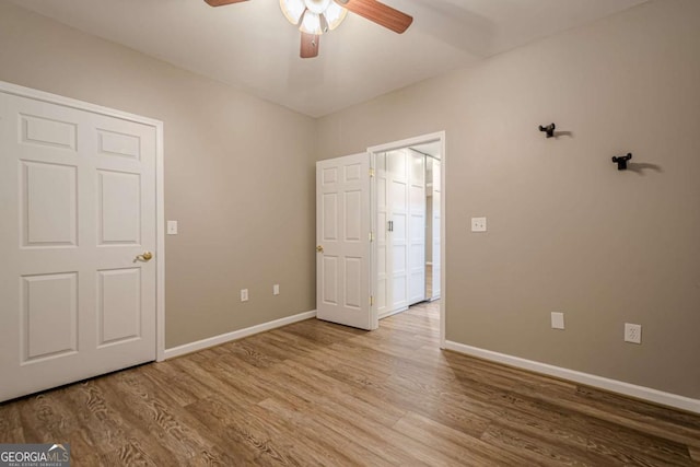 unfurnished bedroom featuring hardwood / wood-style flooring and ceiling fan