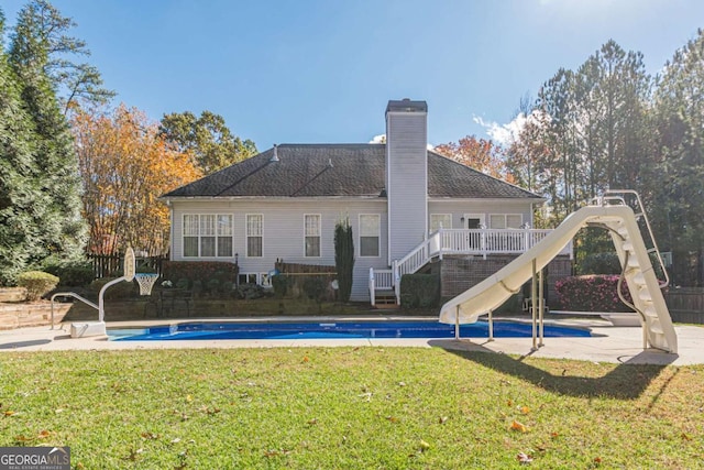 back of property with a lawn and a patio