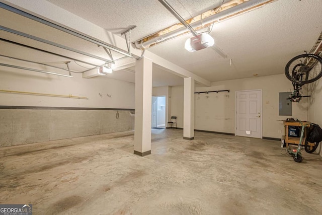 garage featuring electric panel and a garage door opener