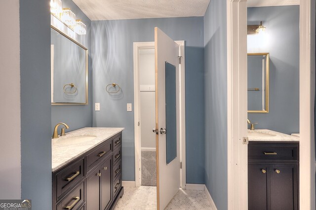 bathroom with vanity and a textured ceiling