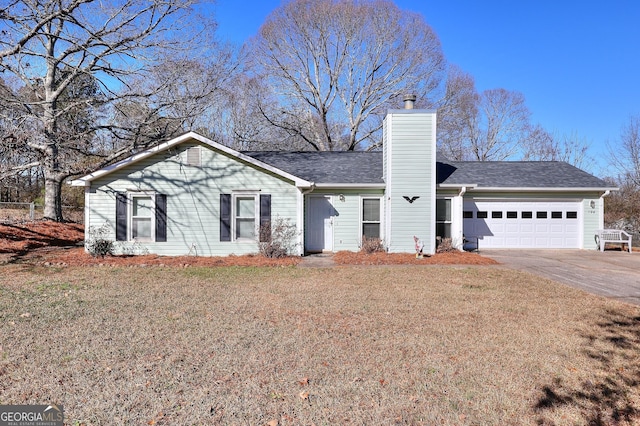 single story home featuring a garage and a front lawn