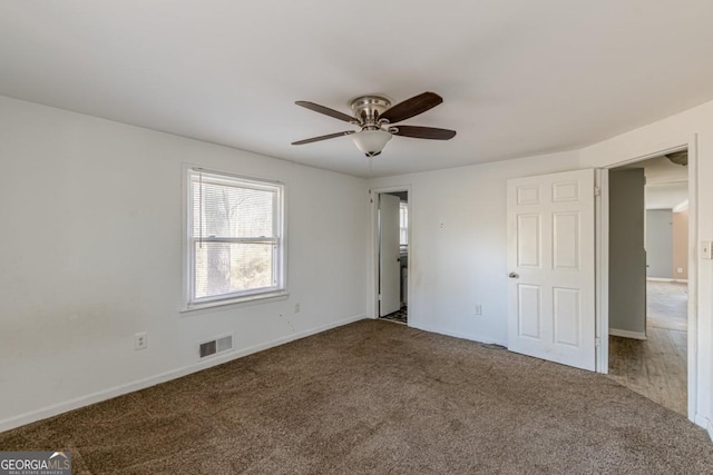 unfurnished bedroom with ceiling fan and carpet floors